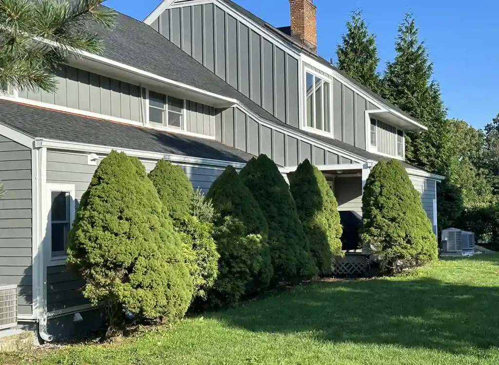 Modern home with green trees and grass